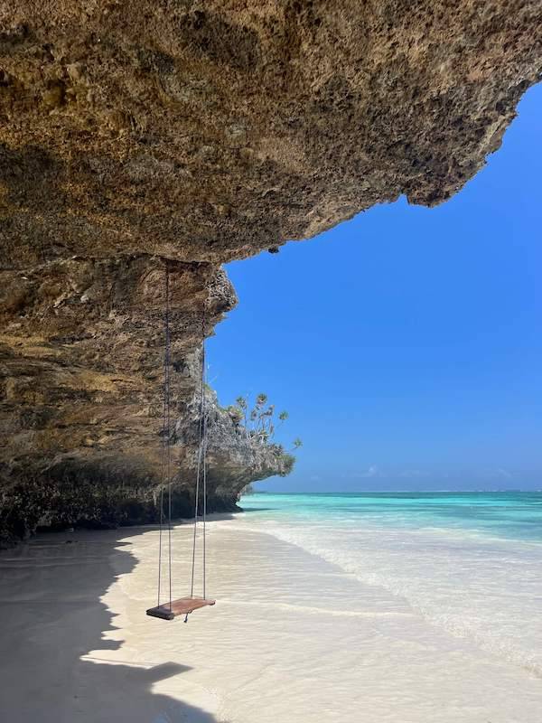 Swing under a coral rock overhang on the beach